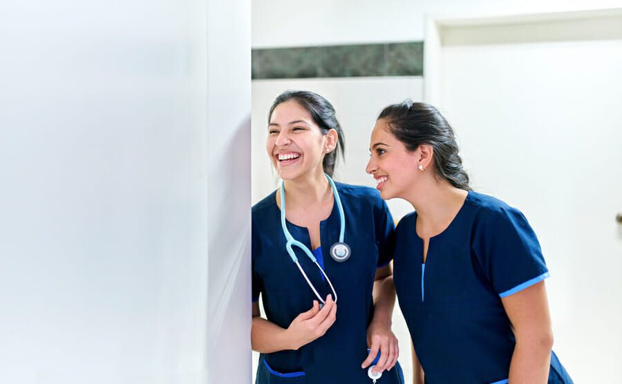 Healthcare: Happy female medical doctors in a hospital. Young medical hospital professionals, happy in healthcare facility. Copy space for text