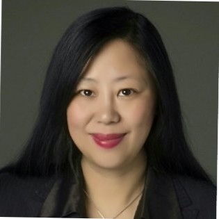 Kelly Zou. An asian adult woman with long hair and red lipstick. Gray background behind head